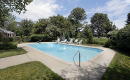 Swimming pool in suburban home with golf course view. poolside patio